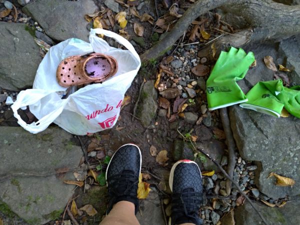 A lone pink croc shoe amid the debris