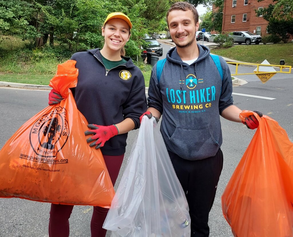 Sweepers in Section 4 at Kennebec St holding bags of trash and recycleables.