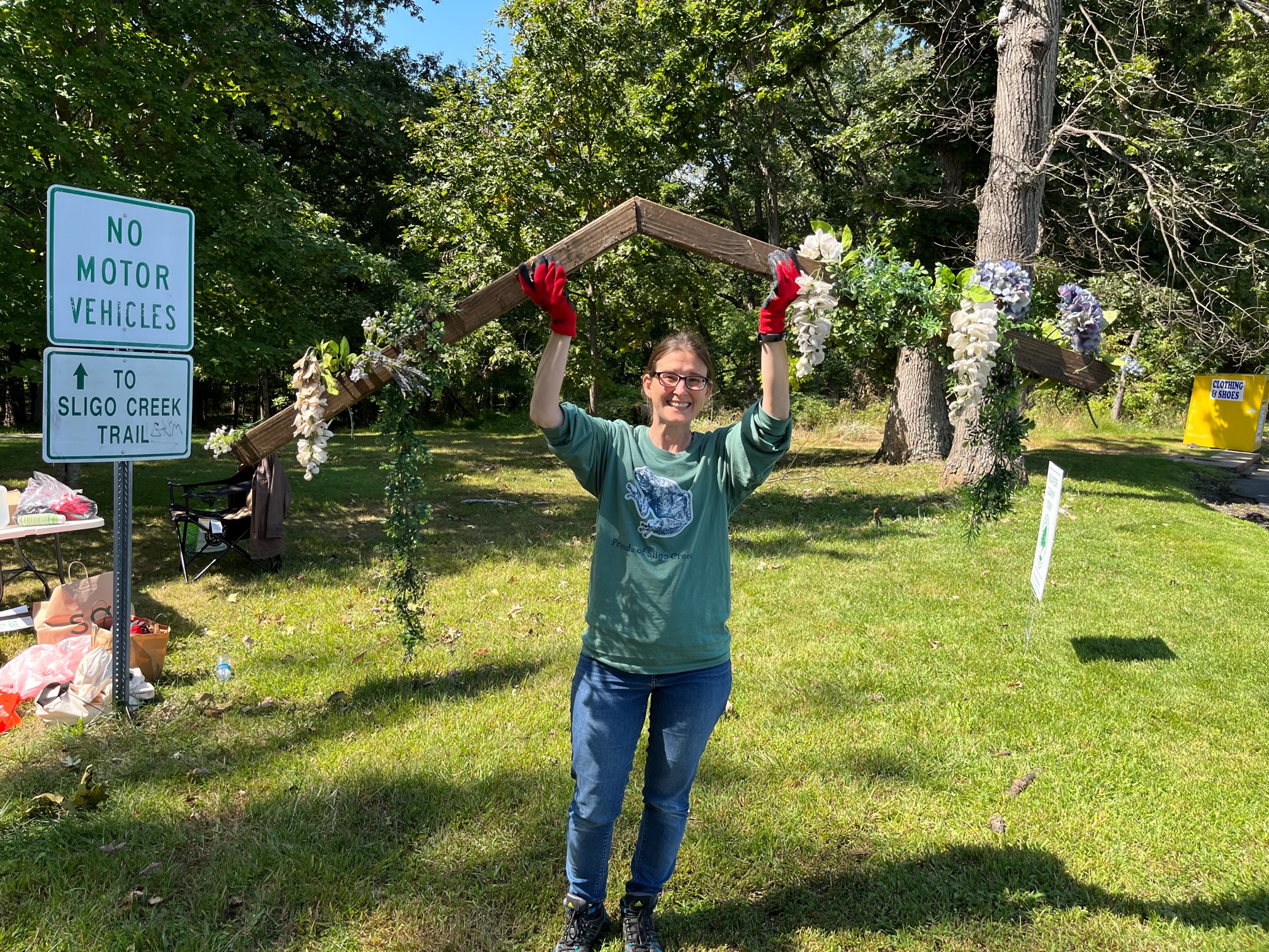 Corinne Stevens with found lumber with plastic flower decoration