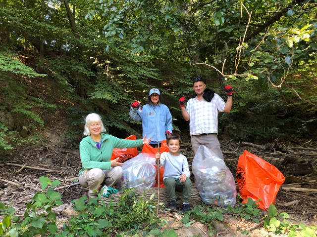 The Carole Highlands sweep the creek team (in part) on the bank of the creek with bags of litter