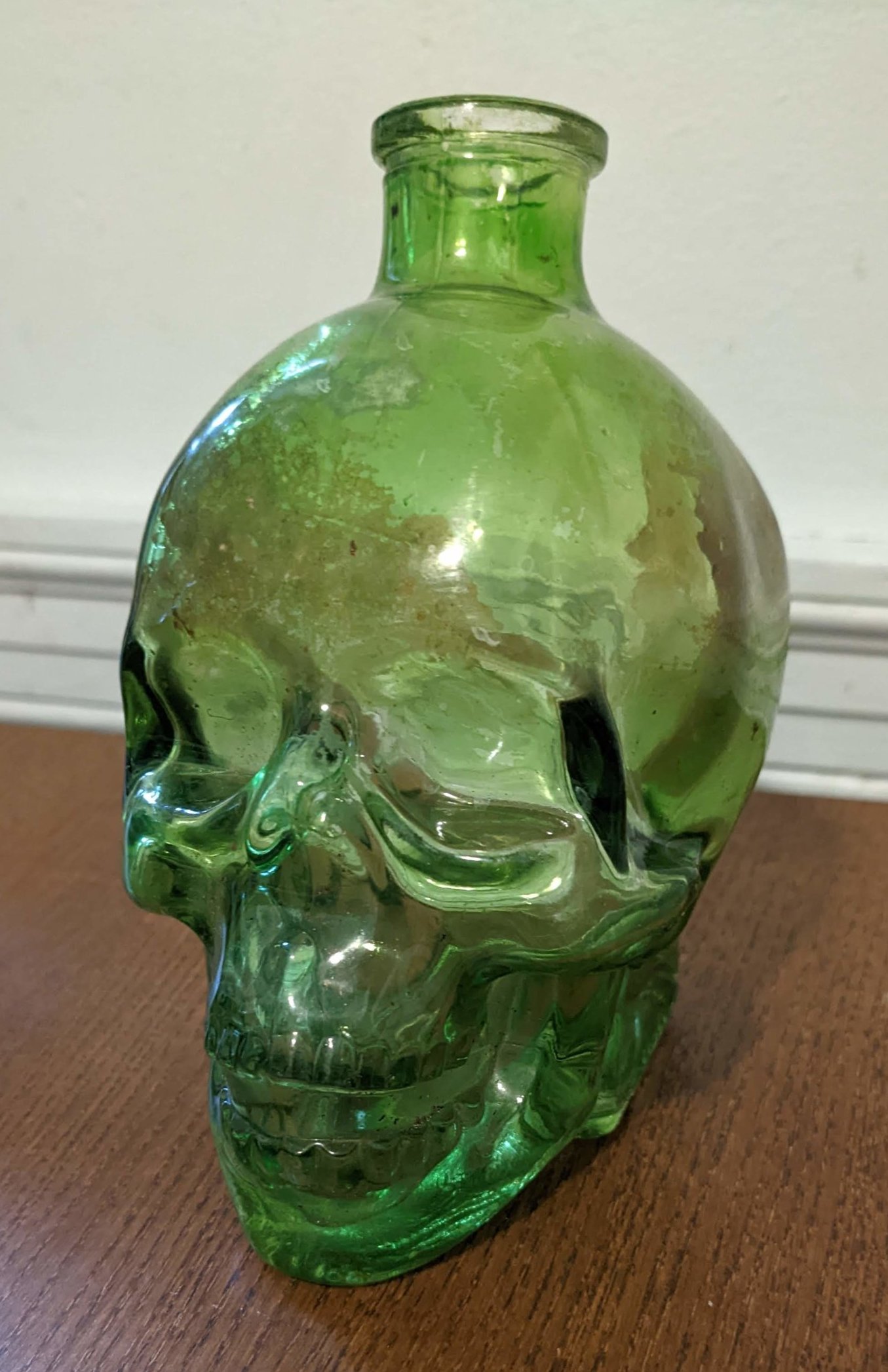 A green glass bottle in the shape of a skull - very seasonal!