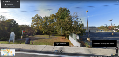 A fence with Sligo Creek park on one side and the proposed 16-pump gas station site on the other.