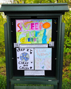 Section 9 Kiosk exhibiting students' artwork about Sweeping the Creek of litter.