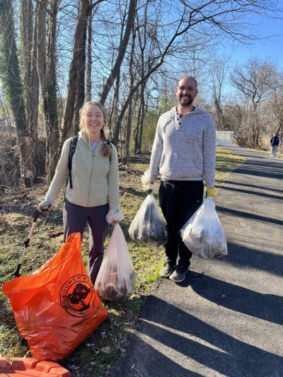 Two volunteers with bags of trash they cleared from Section 1 of Sligo Creek during the President's Day cleanup.